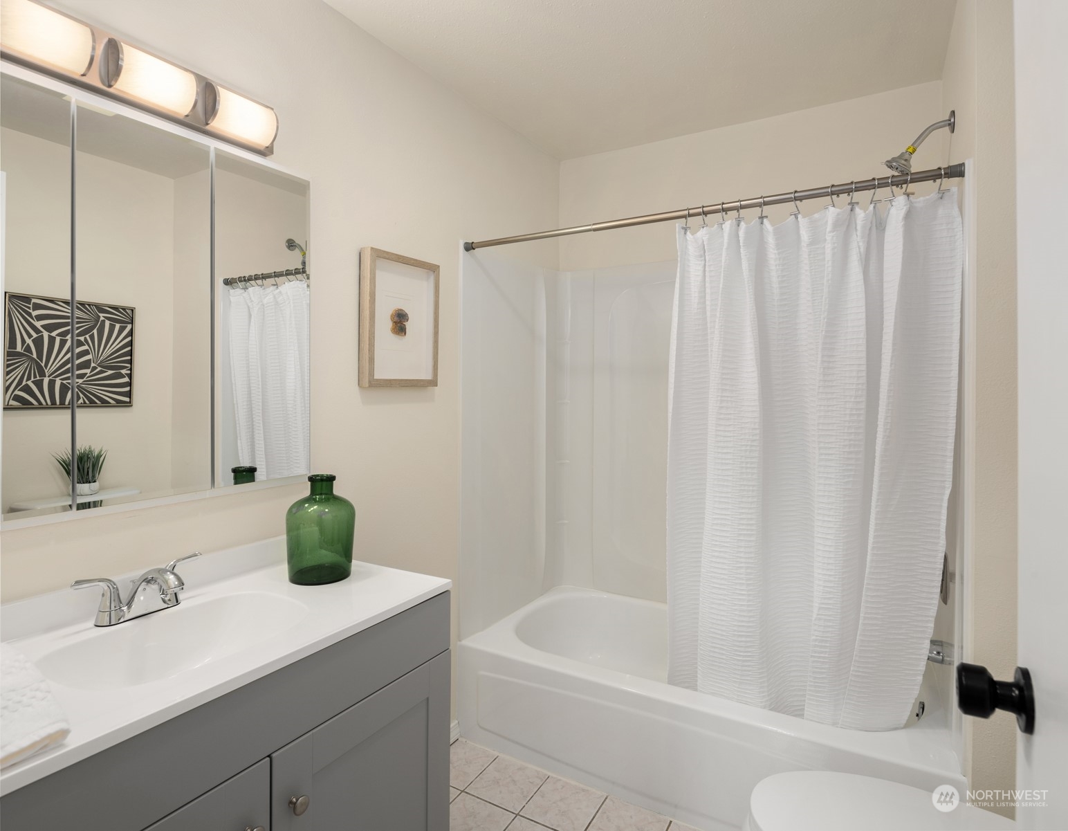 4103 223rd Street Southwest Mountlake Terrace, WA 98043 - Photo 16 of 38 a bathroom with a sink a toilet and shower