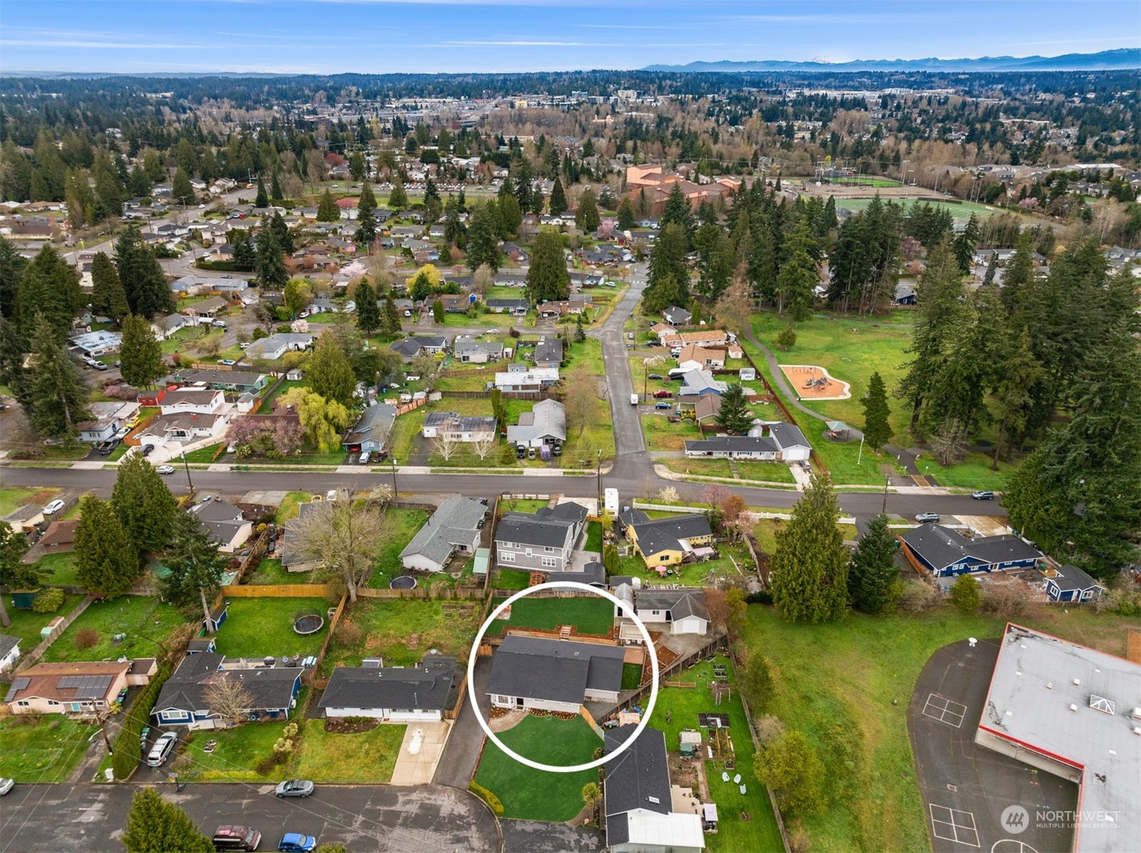4103 223rd Street Southwest Mountlake Terrace, WA 98043 - Photo 38 of 38 an aerial view of residential houses with outdoor space and swimming pool