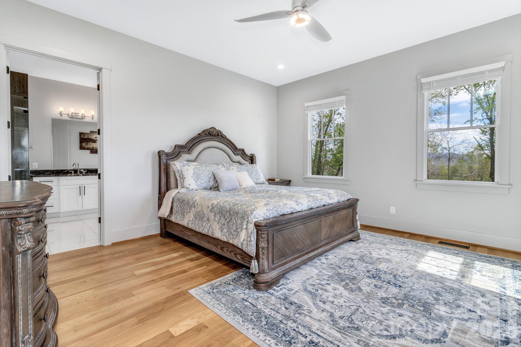 301 Rockbridge Road Mills River, NC 28759 - Photo 22 of 48 a bedroom with a bed and a dresser with wooden floor