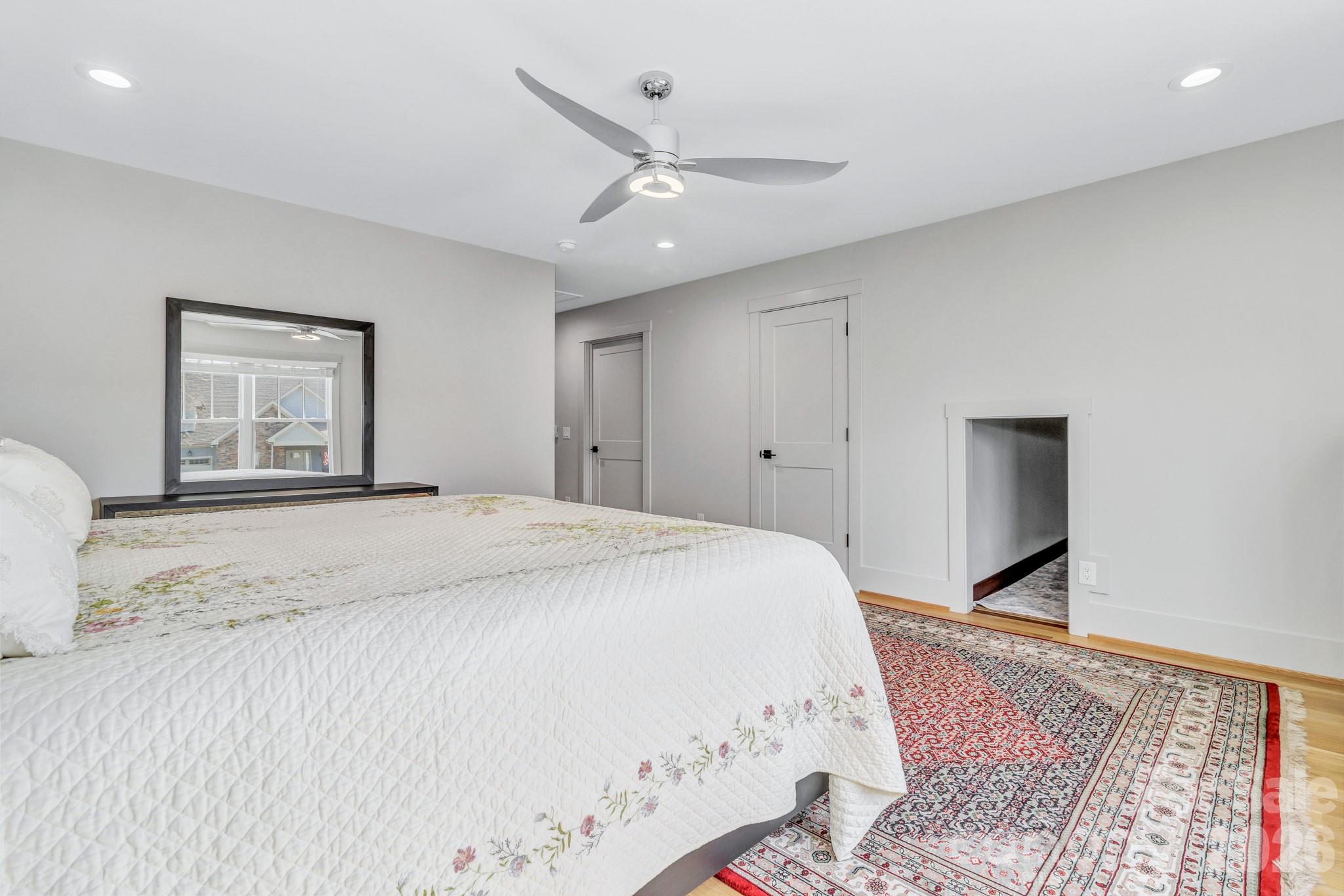 301 Rockbridge Road Mills River, NC 28759 - Photo 40 of 48 a bedroom with a large bed and a chandelier