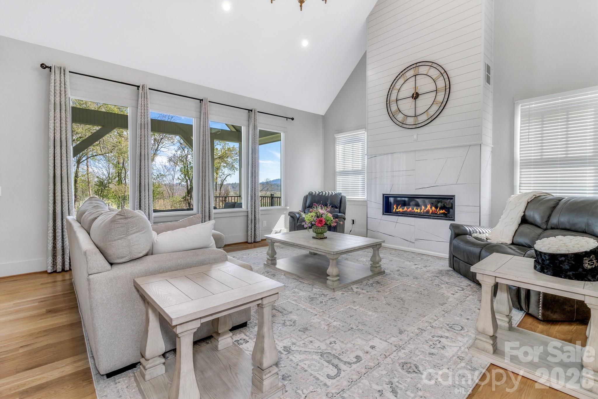 301 Rockbridge Road Mills River, NC 28759 - Photo 10 of 48 a living room with furniture a fireplace and a floor to ceiling window