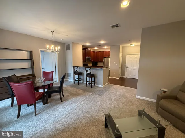 a view of a livingroom with furniture and a window