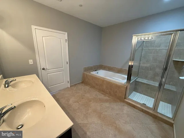 a bathroom with a double vanity sink and a mirror