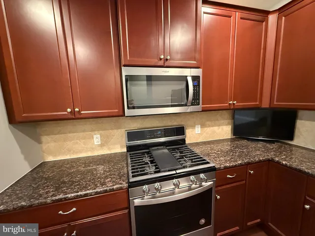 a kitchen with a refrigerator and a stove