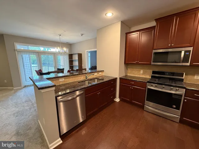 a living room with a couch and a dresser with wooden floor