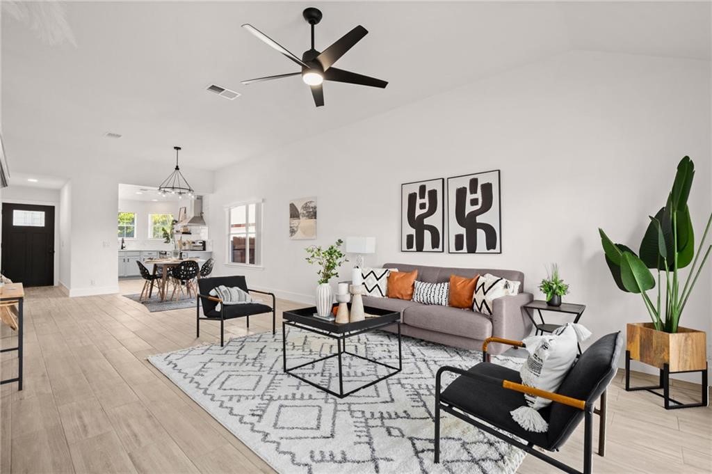 16724 Trevin Cove Manor, TX 78653 - Photo 12 of 32 a living room with furniture and a chandelier
