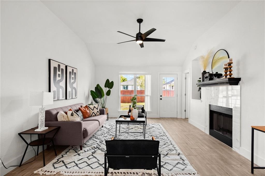 16724 Trevin Cove Manor, TX 78653 - Photo 16 of 32 a living room with furniture and a fireplace