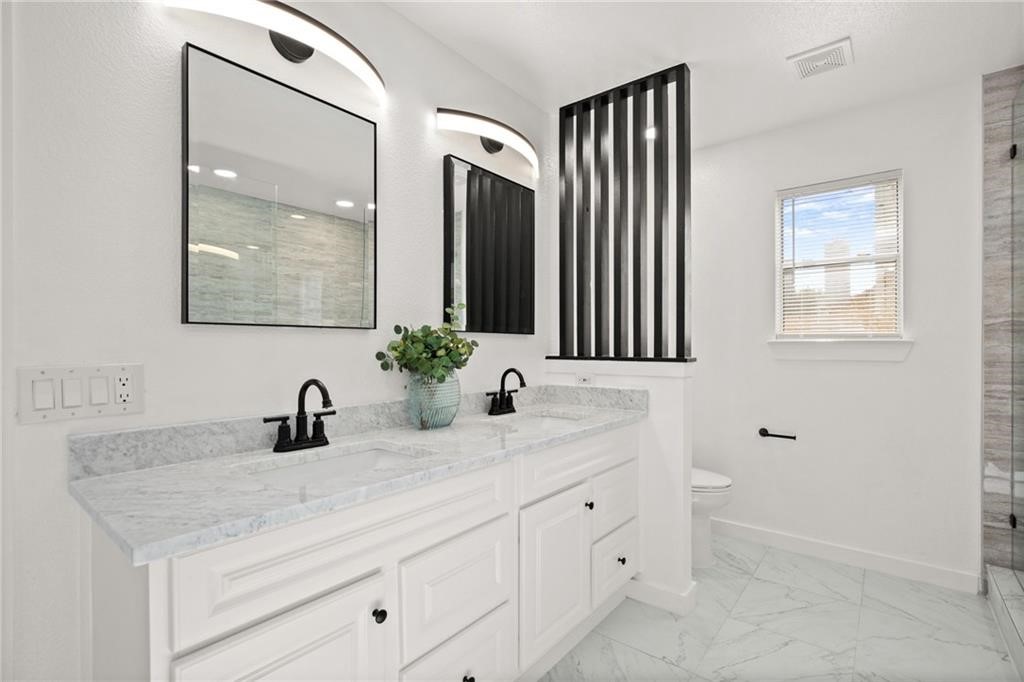 16724 Trevin Cove Manor, TX 78653 - Photo 19 of 32 a bathroom with a sink and a mirror