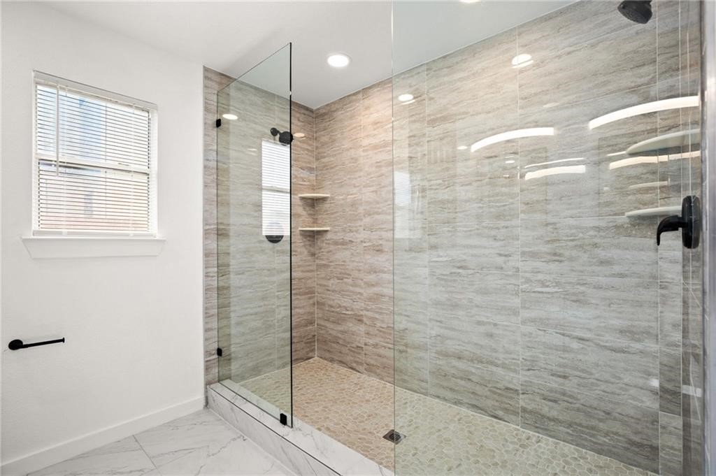 16724 Trevin Cove Manor, TX 78653 - Photo 20 of 32 a bathroom with a shower