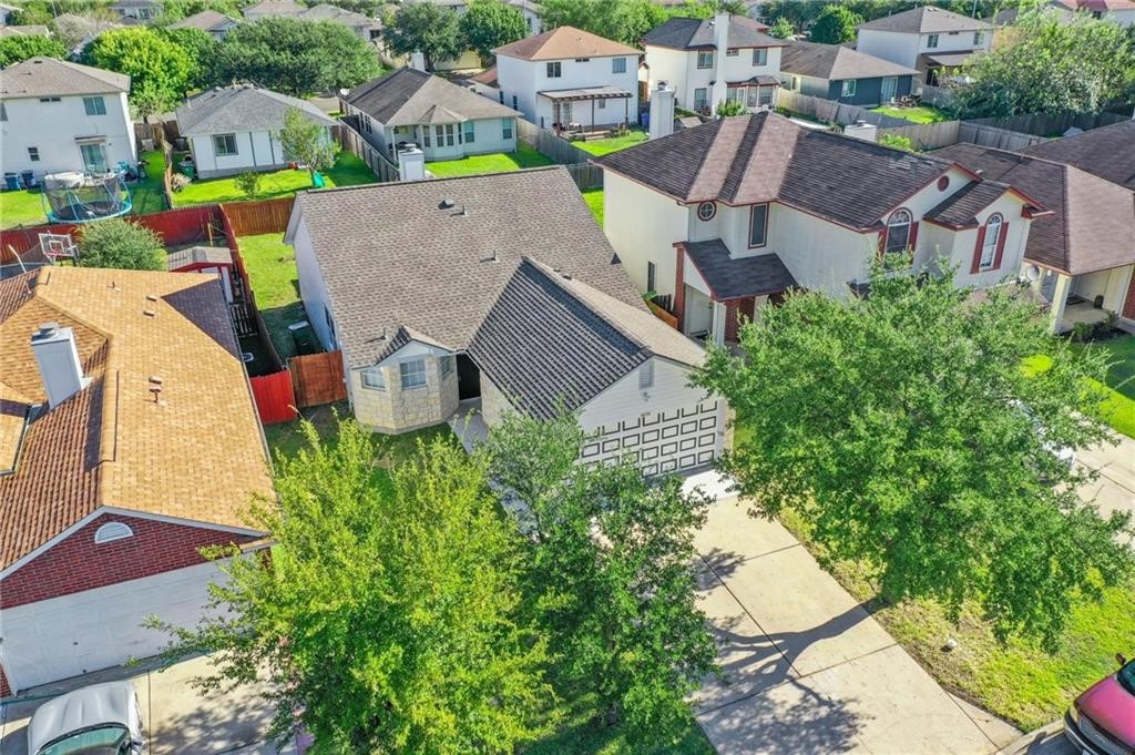 16724 Trevin Cove Manor, TX 78653 - Photo 2 of 32 an aerial view of multiple houses with yard