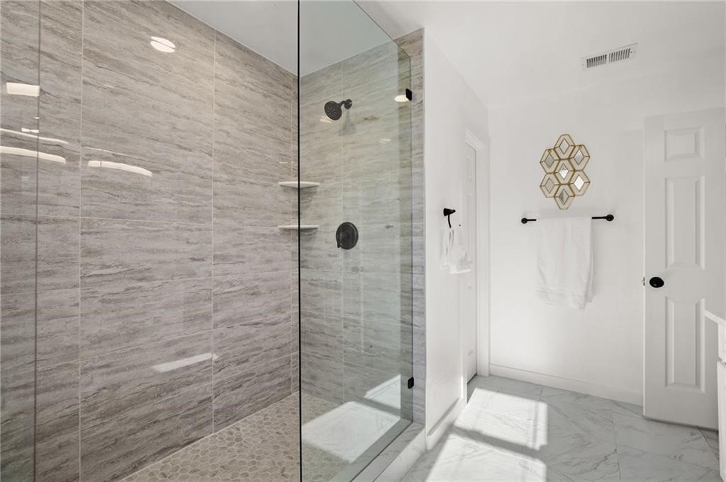 16724 Trevin Cove Manor, TX 78653 - Photo 21 of 32 a bathroom with a shower