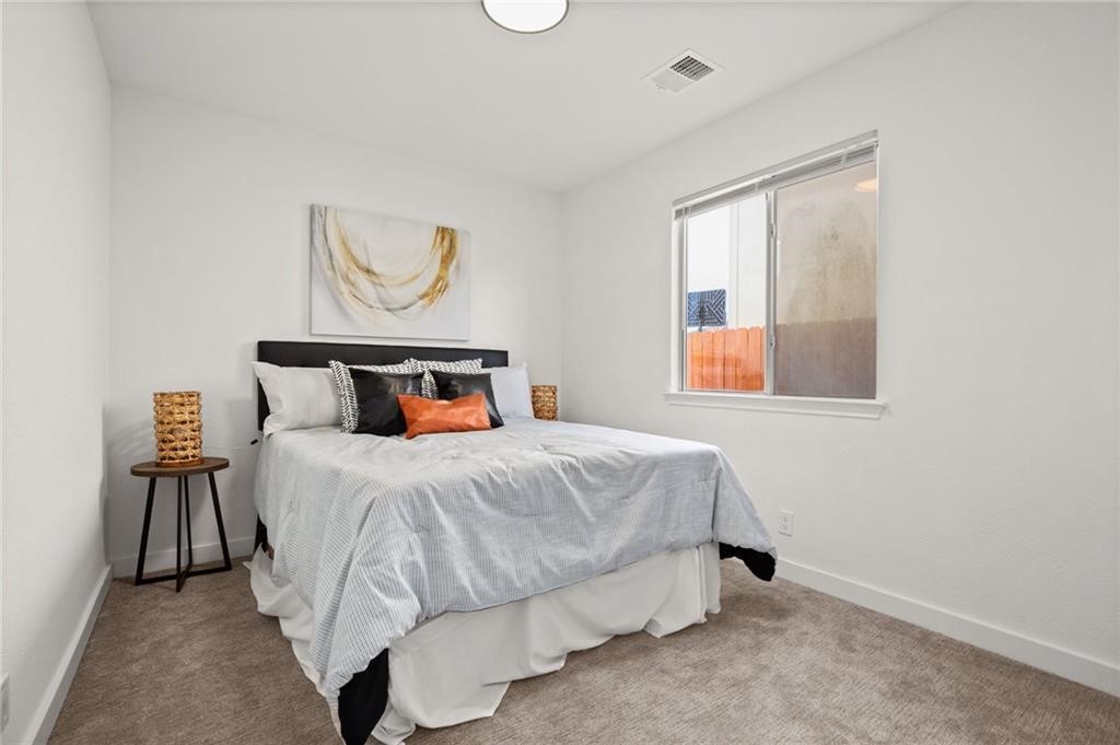16724 Trevin Cove Manor, TX 78653 - Photo 25 of 32 a bedroom with a bed and window