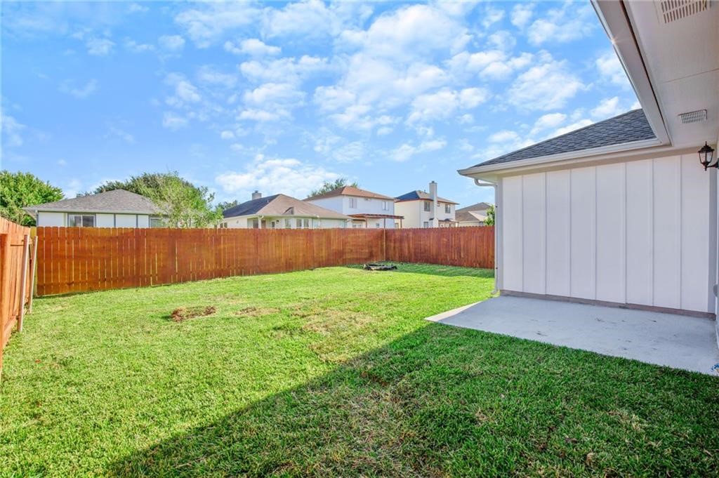 16724 Trevin Cove Manor, TX 78653 - Photo 27 of 32 a view of a backyard with a garden