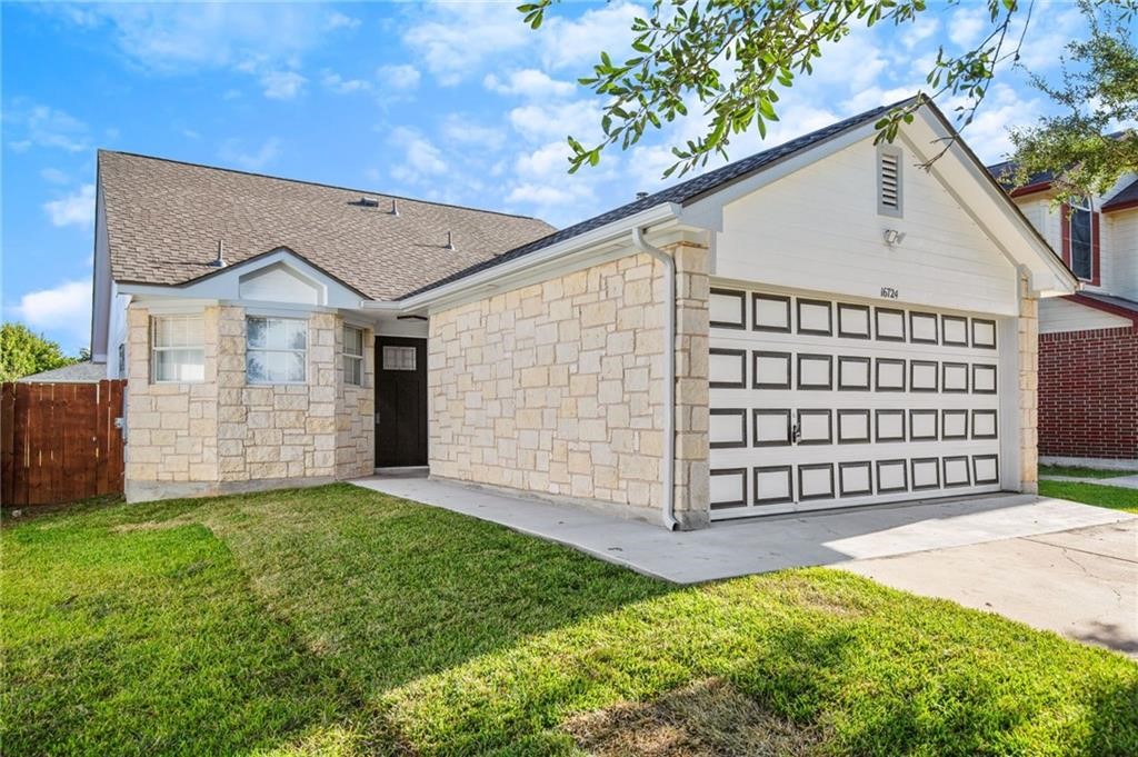 16724 Trevin Cove Manor, TX 78653 - Photo 3 of 32 a view of a house with a yard and garage