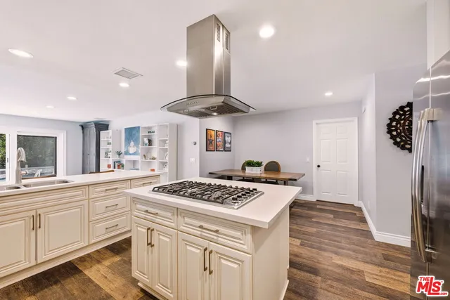 a kitchen with stainless steel appliances a stove a sink and a refrigerator
