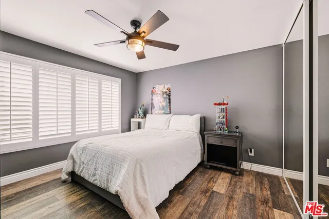 a bedroom with a bed and a large window