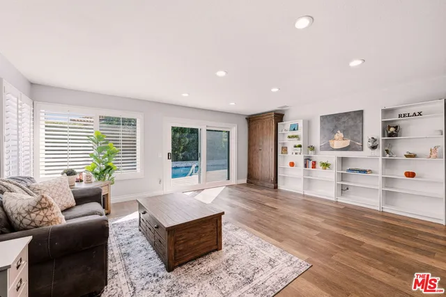 a living room with furniture window and wooden floor