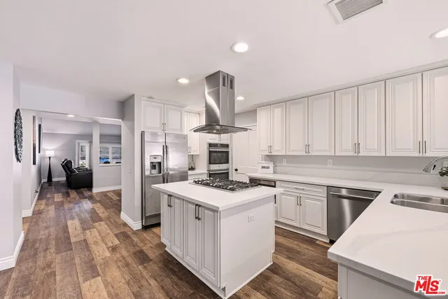 a kitchen with a stove and a white cabinets