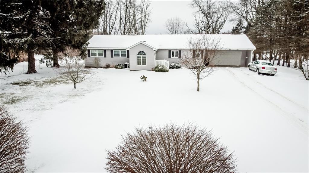 130 Minteer Road Butler, PA 16001 - Photo 3 of 24 a view of a white house with a yard covered in snow