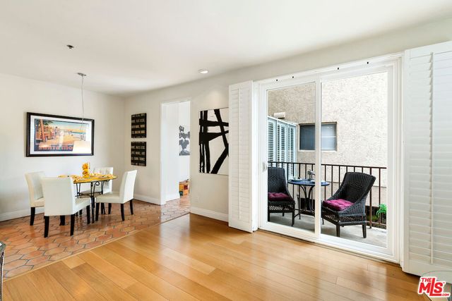 a living room with furniture a rug and white walls