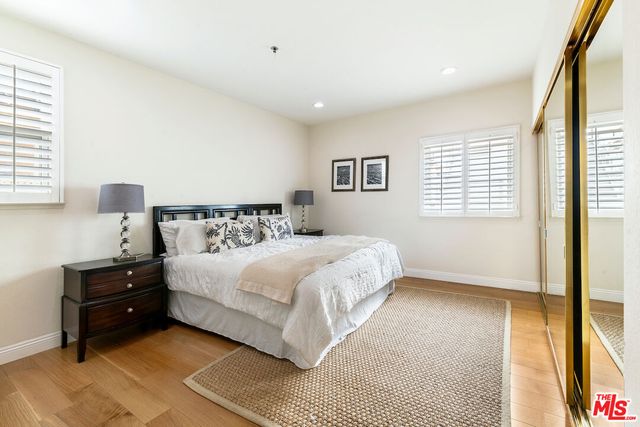 a bedroom with a bed and a night stand