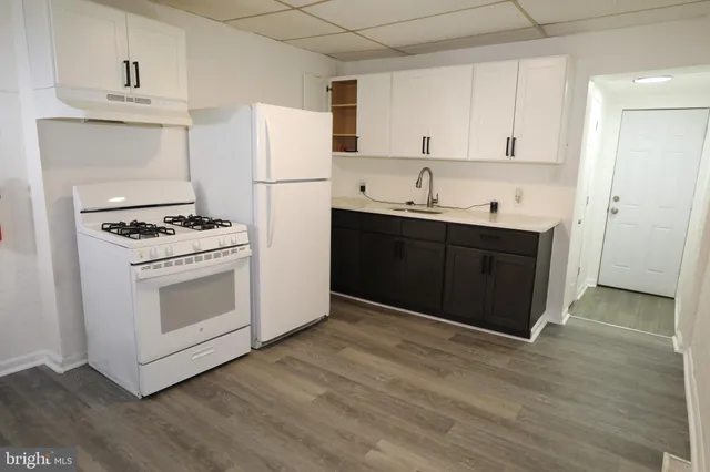 a kitchen with stainless steel appliances granite countertop a stove a refrigerator and a sink