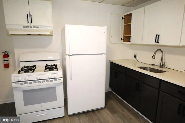 a kitchen with a stove cabinets and refrigerator