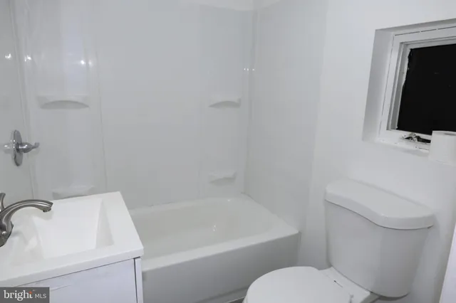 a bathroom with a toilet sink and bathtub