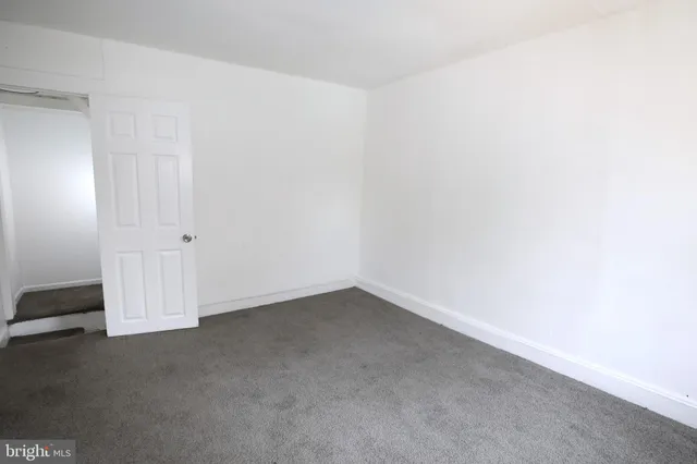 an empty room with white walls