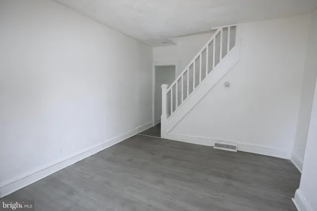 a view of room with stairs and wooden floor