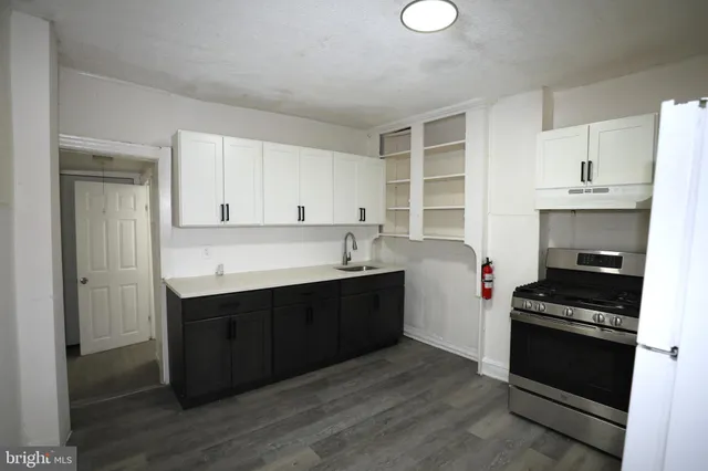 a kitchen with a sink and a stove top oven