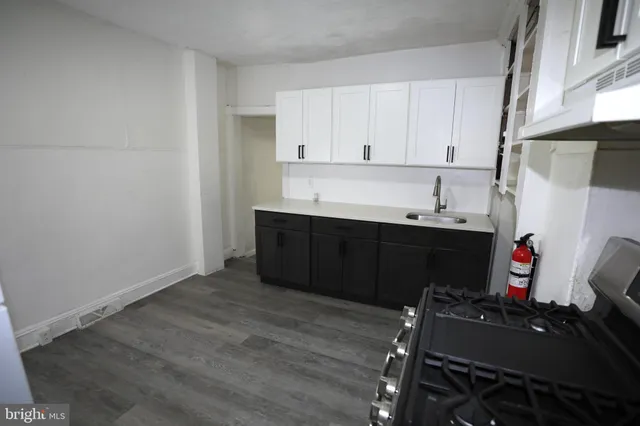 a room with a sink and cabinets