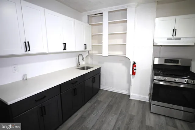 a kitchen with a sink cabinets and a window