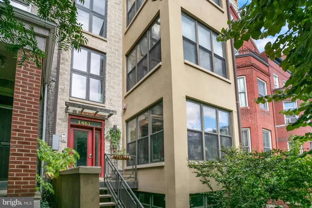 a view of a building with a lot of windows and plants