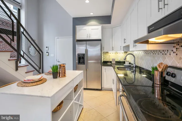 a kitchen with refrigerator and stove