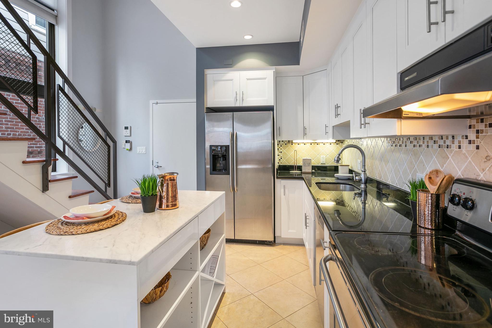 1461 Harvard Street Northwest, Unit 5 Washington, DC 20009 - Photo 11 of 33 a kitchen with refrigerator and stove