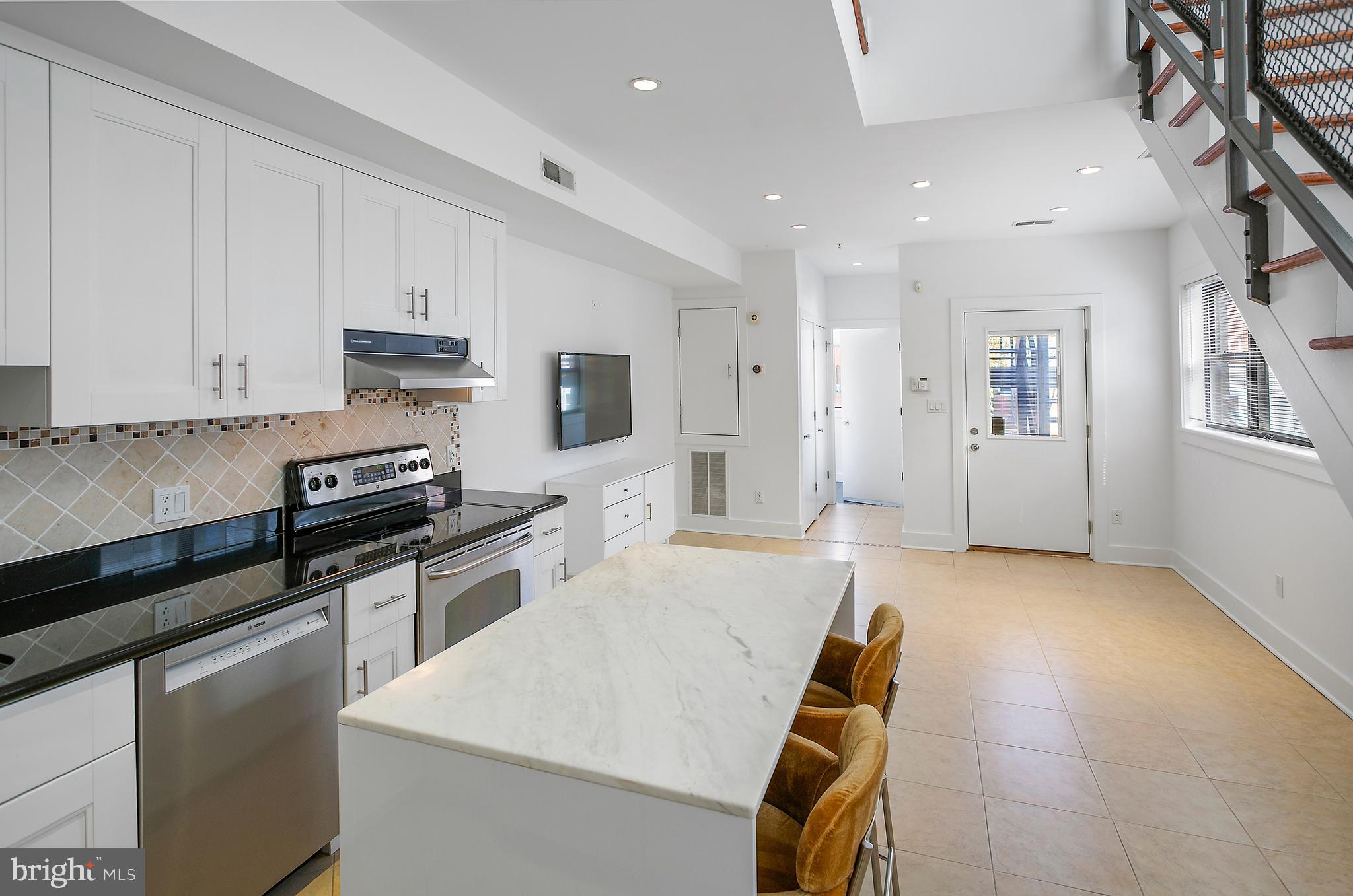 1461 Harvard Street Northwest, Unit 5 Washington, DC 20009 - Photo 13 of 33 a kitchen with a stove a sink and a refrigerator