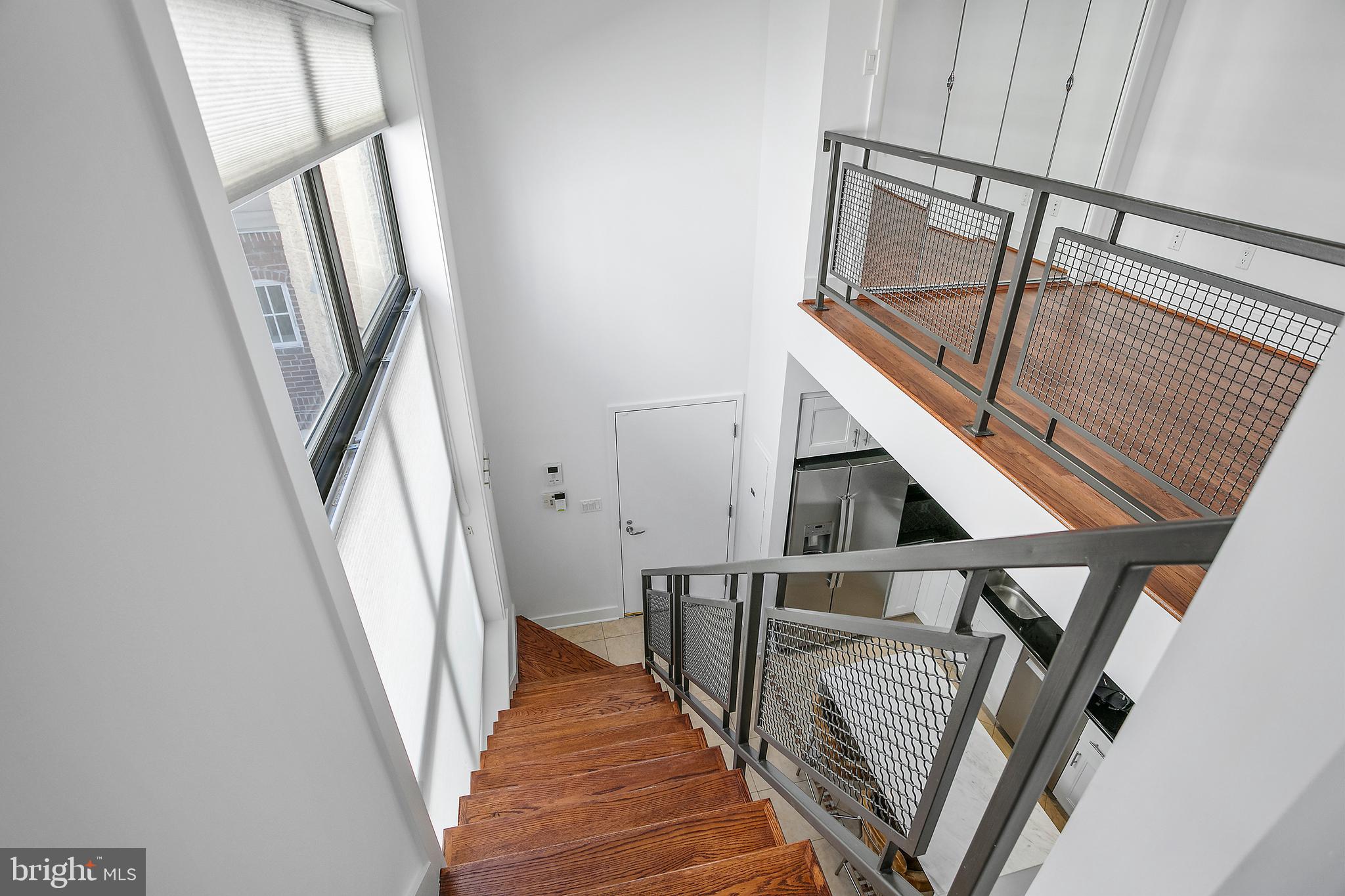1461 Harvard Street Northwest, Unit 5 Washington, DC 20009 - Photo 17 of 33 a view of staircase with white walls and railing