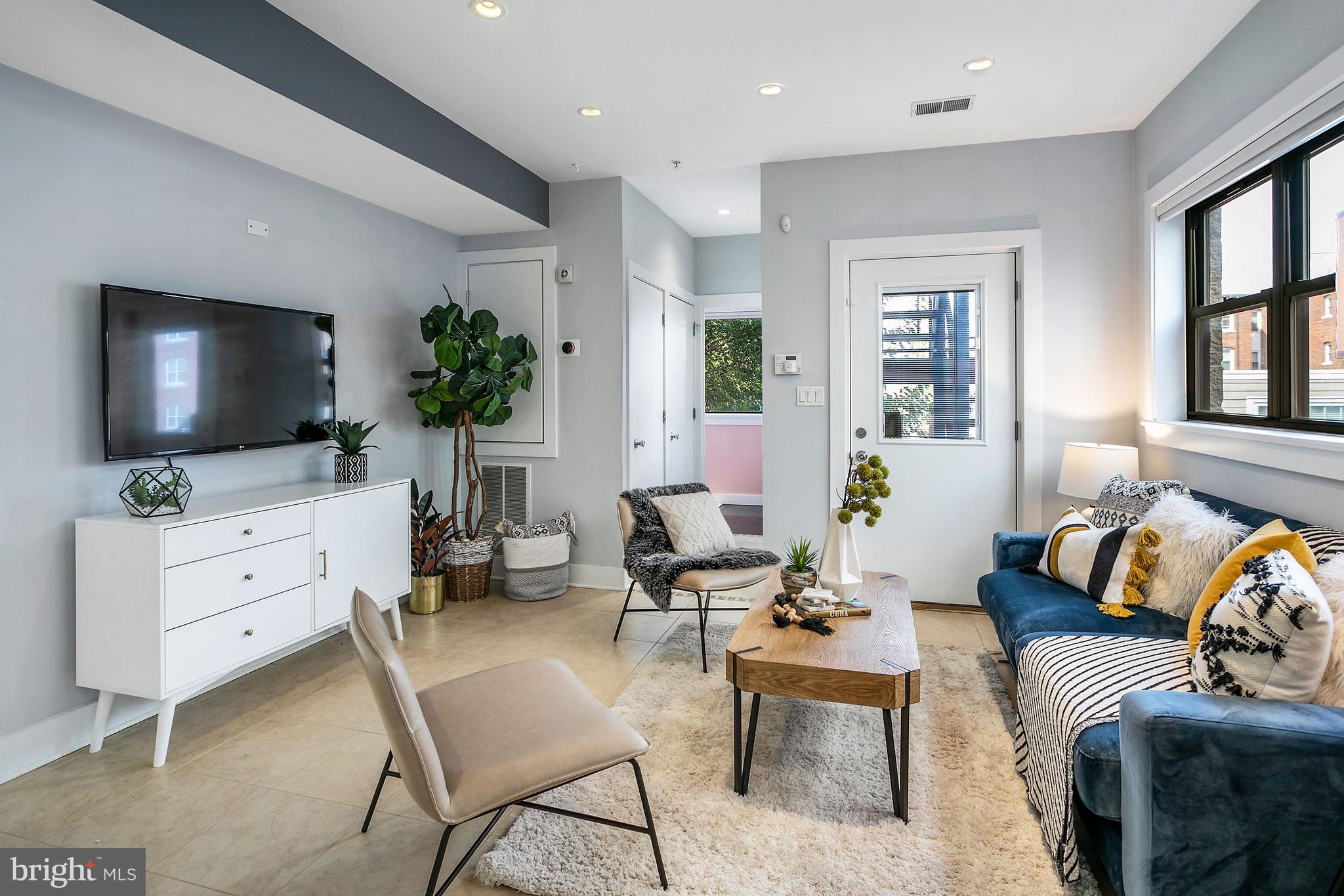 1461 Harvard Street Northwest, Unit 5 Washington, DC 20009 - Photo 2 of 33 a living room with furniture and a flat screen tv