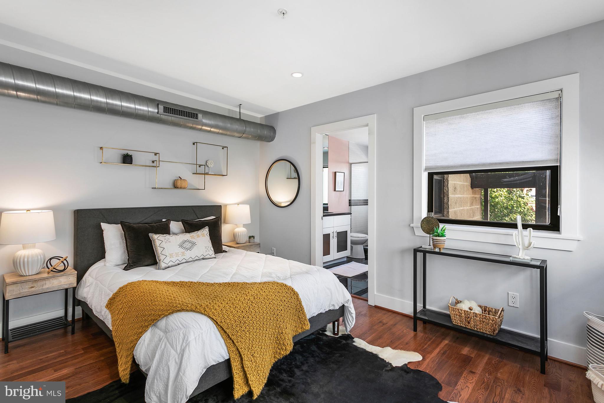 1461 Harvard Street Northwest, Unit 5 Washington, DC 20009 - Photo 20 of 33 a bed room with a bed and a tv