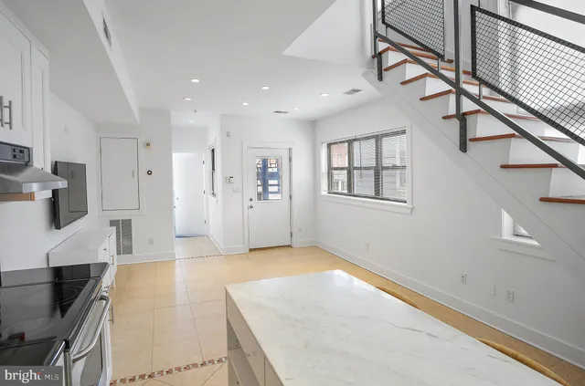 a view of livingroom with furniture and workspace
