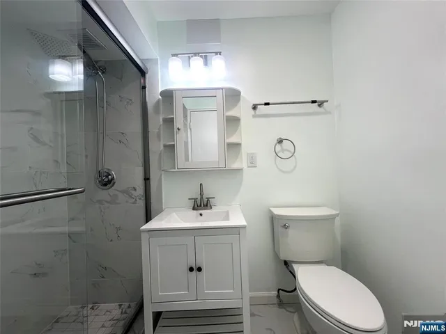 a bathroom with a toilet a sink and mirror