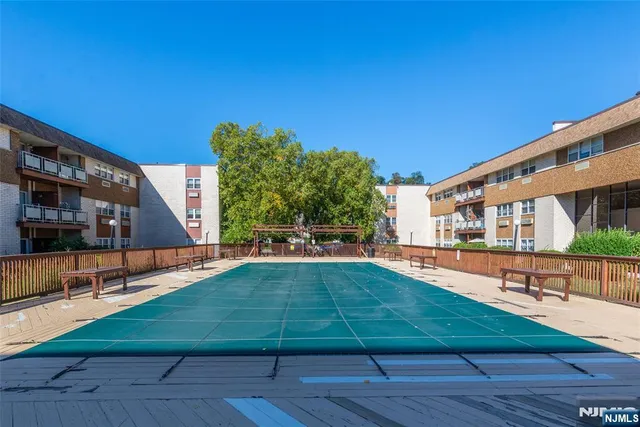 a view of a house with swimming pool and sitting area