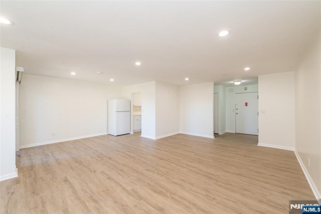 1111 River Road, Unit G5 Edgewater, NJ 07020 - Photo 3 of 20 a view of an empty room with wooden floor