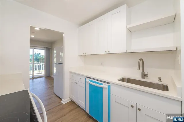 a kitchen with a sink and cabinets