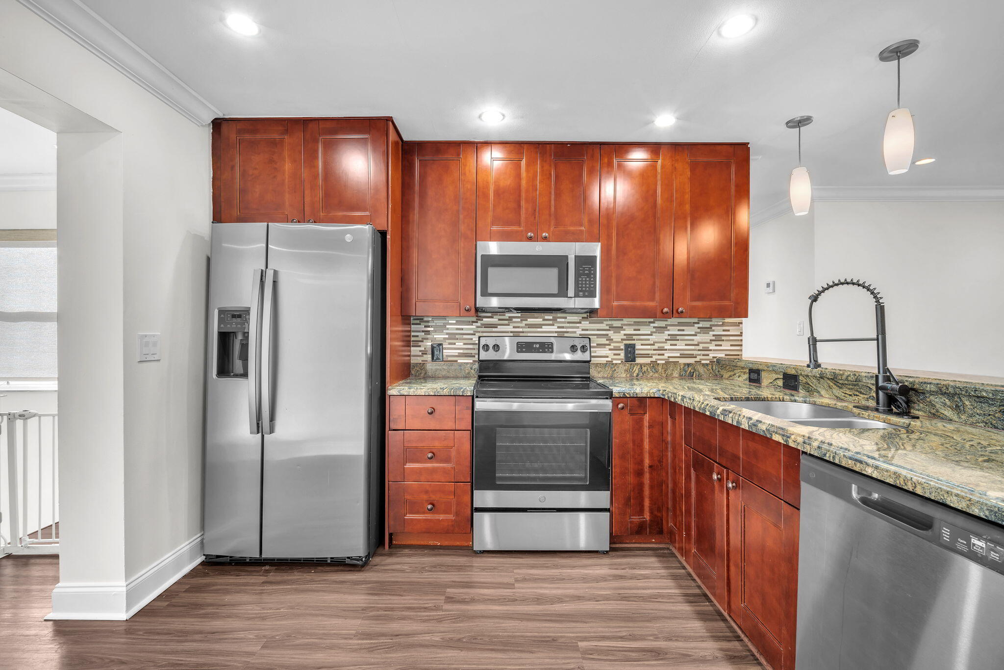 144 Northwest 4th Avenue Boca Raton, FL 33432 - Photo 12 of 35 a kitchen with stainless steel appliances granite countertop a refrigerator and a sink