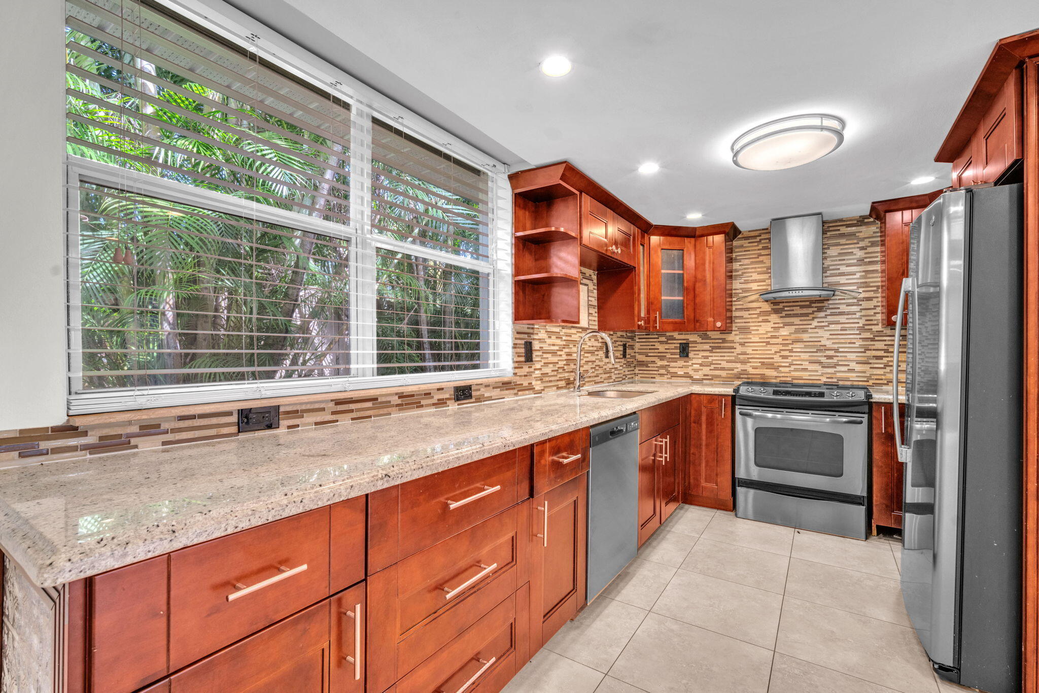 144 Northwest 4th Avenue Boca Raton, FL 33432 - Photo 19 of 35 a kitchen with stainless steel appliances granite countertop a sink and stove