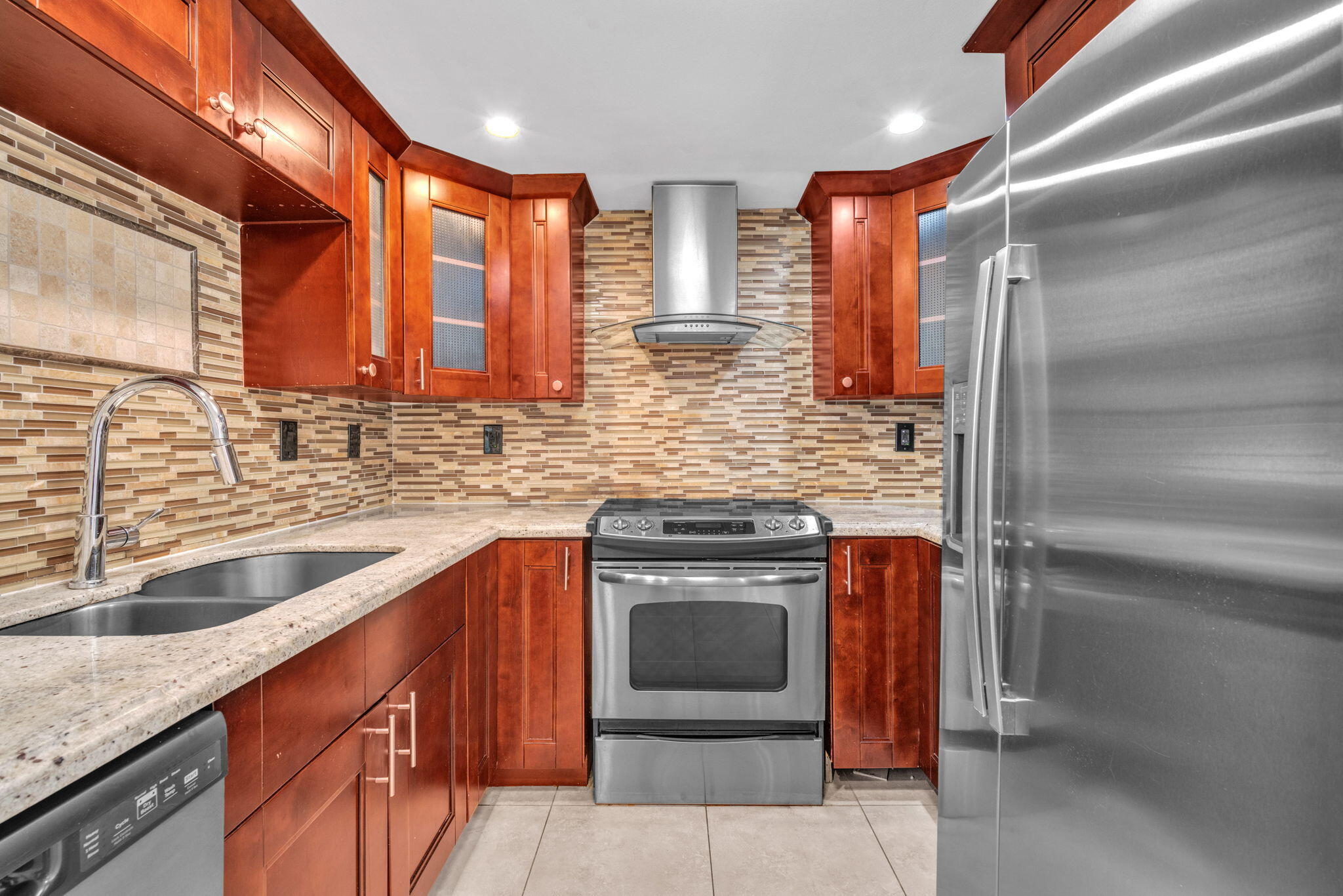 144 Northwest 4th Avenue Boca Raton, FL 33432 - Photo 20 of 35 a kitchen with stainless steel appliances granite countertop a sink stove and refrigerator