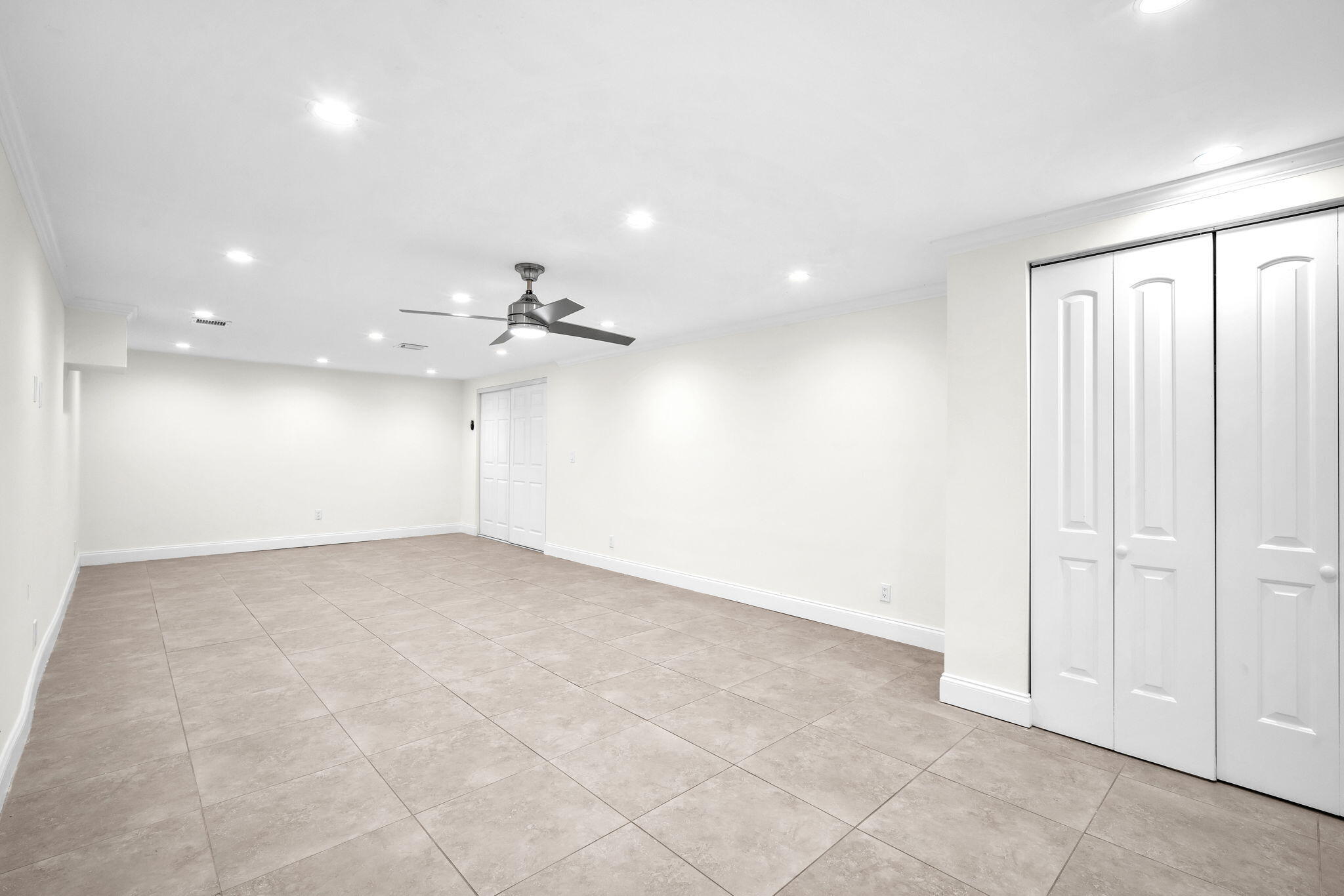 144 Northwest 4th Avenue Boca Raton, FL 33432 - Photo 26 of 35 an empty room with an entryway and fan