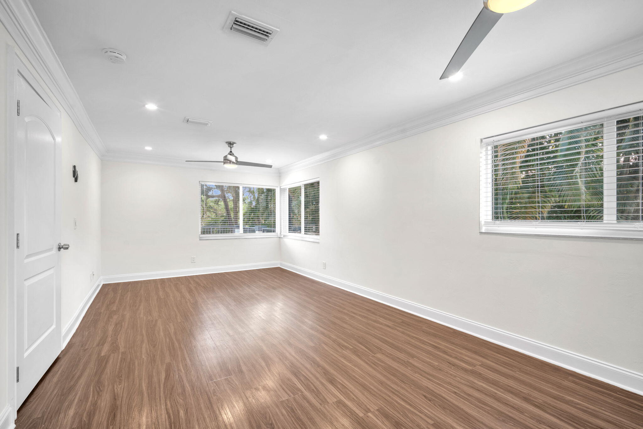 144 Northwest 4th Avenue Boca Raton, FL 33432 - Photo 28 of 35 a view of an empty room with wooden floor and a window